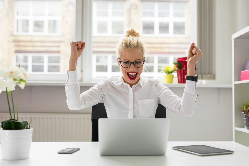 Woman celebrates successful negotiation resolution.